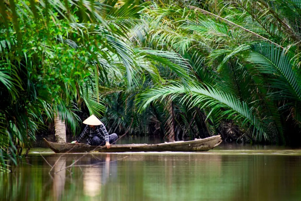 Man in bootje op de Mekong Delta in Vietnam